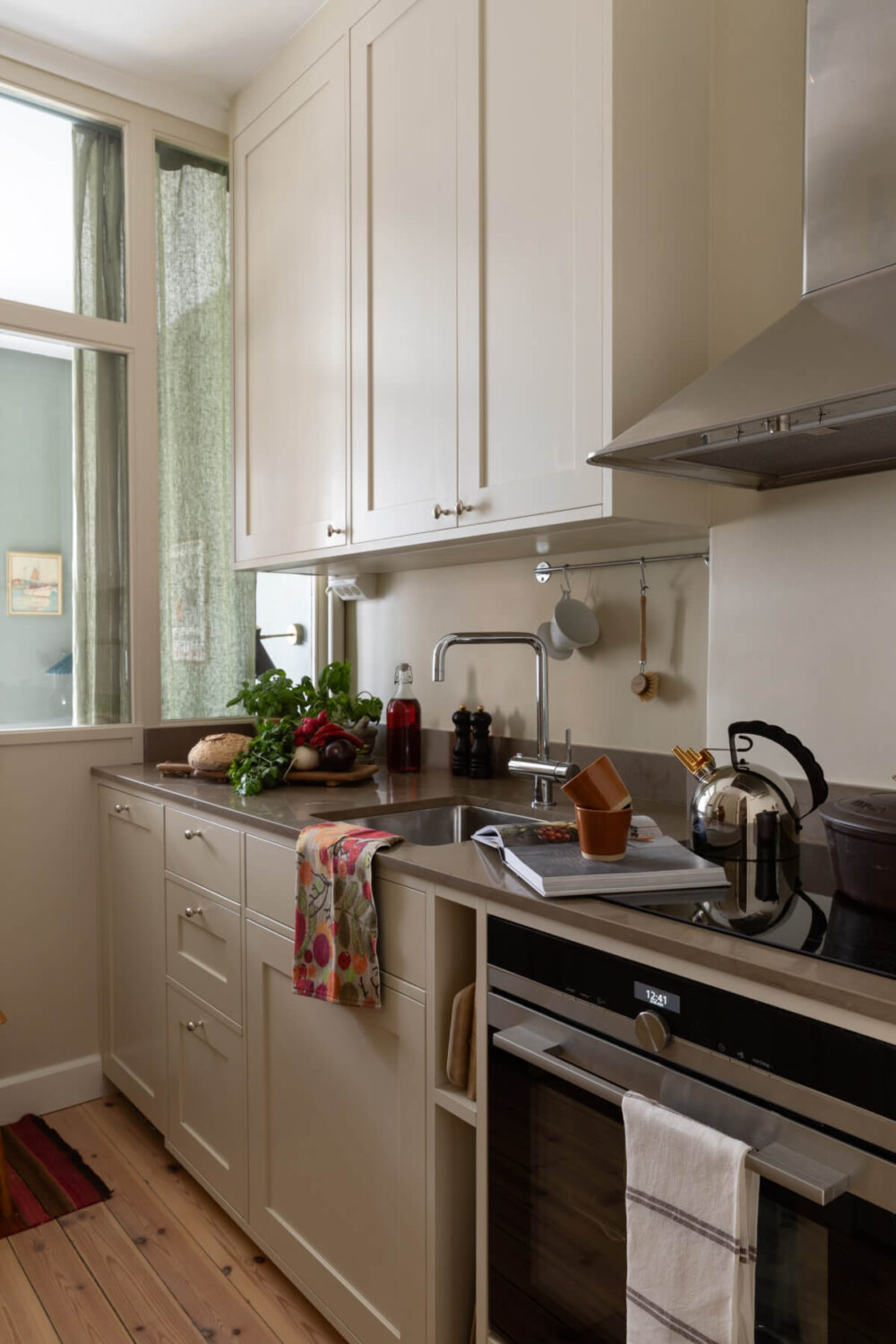 A Nice Color Palette and Original Elements in a Cozy 1930s Apartment 15 kitchen white cabinets glass wall
