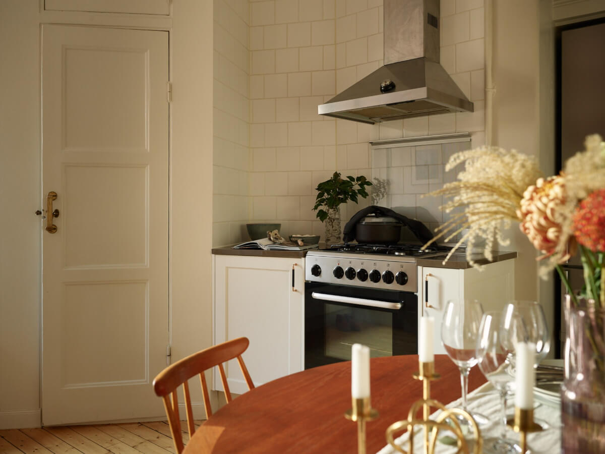 Historic Charm and an Industrial Glass Wall in a Stockholm Apartment 7 kitchen white tiles pantry cabinet