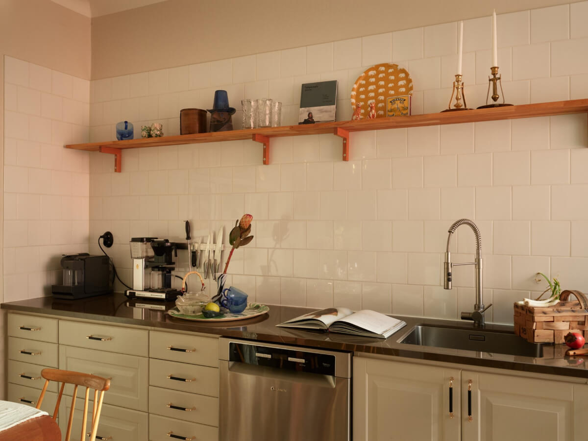 Historic Charm and an Industrial Glass Wall in a Stockholm Apartment 6 kitchen white tiles wooden shelf
