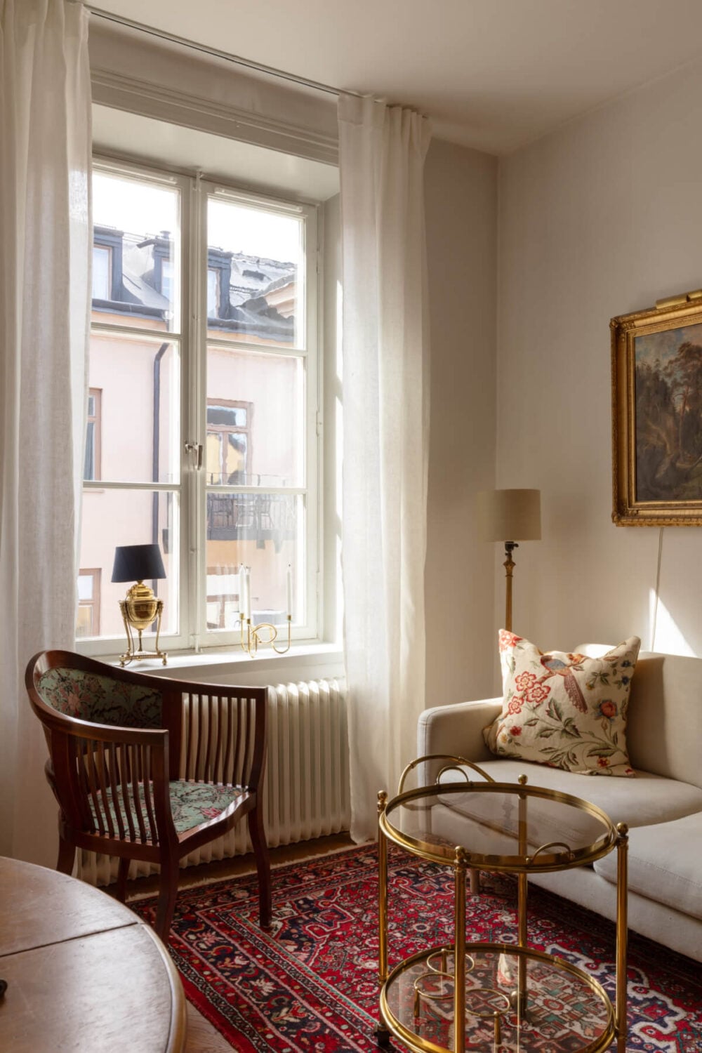 Antiques and Modern Additions in a Cozy Top Floor Duplex Apartment 3 large window living room classic furniture