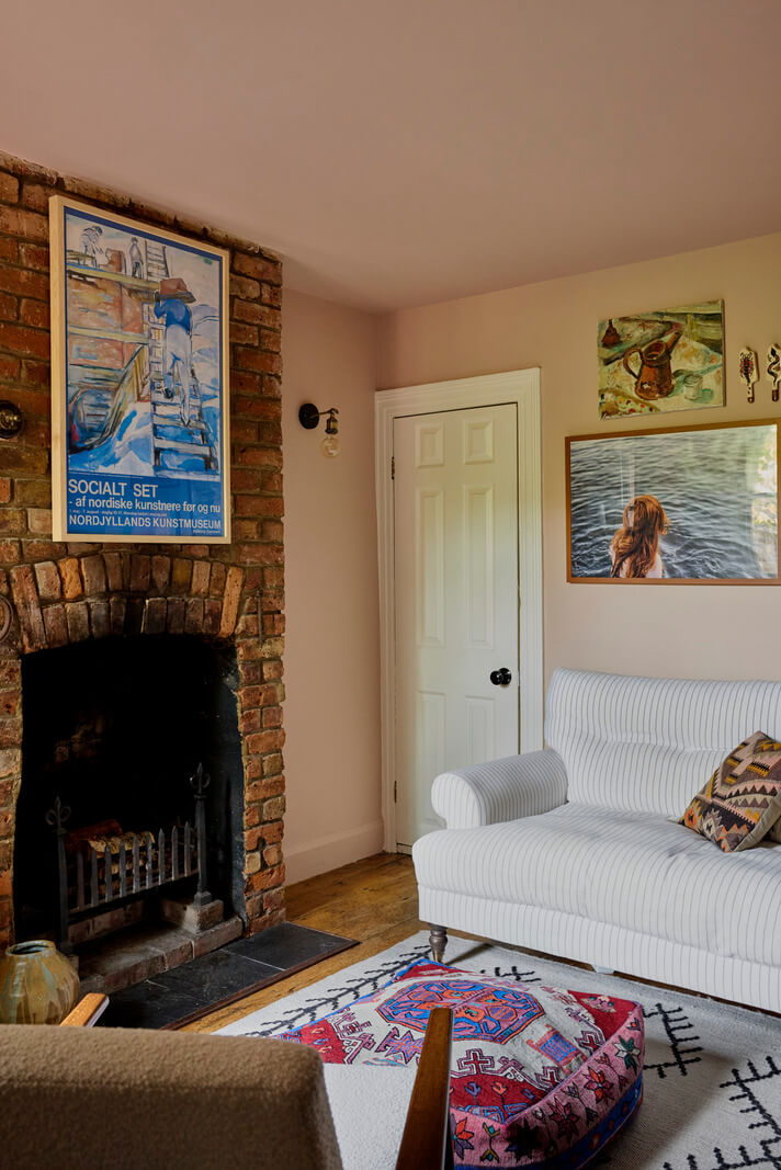 Cozy Living Spaces and Limewash Walls in an Artist's English Home 7 light pink sitting room brick fireplac