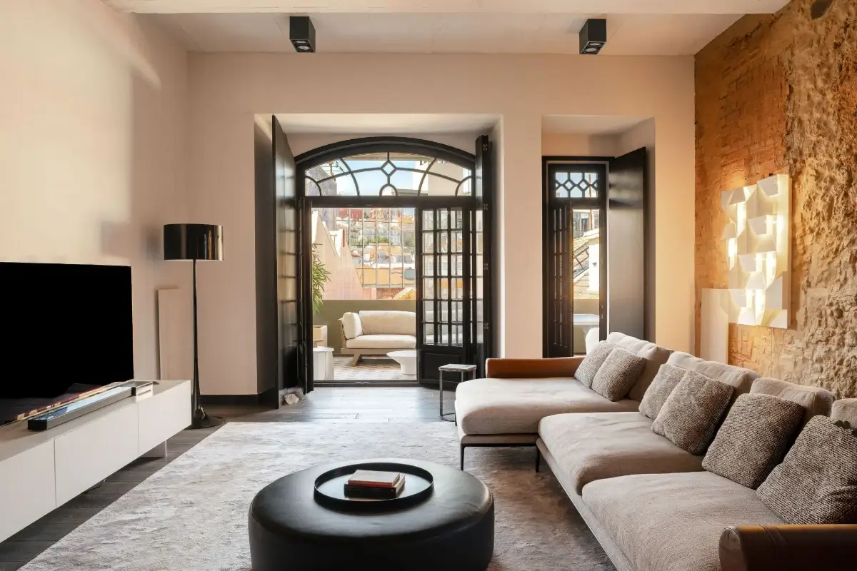An Eye-Catching Stone Wall in a Beautiful Lisbon Apartment 1 living room stone feature wall