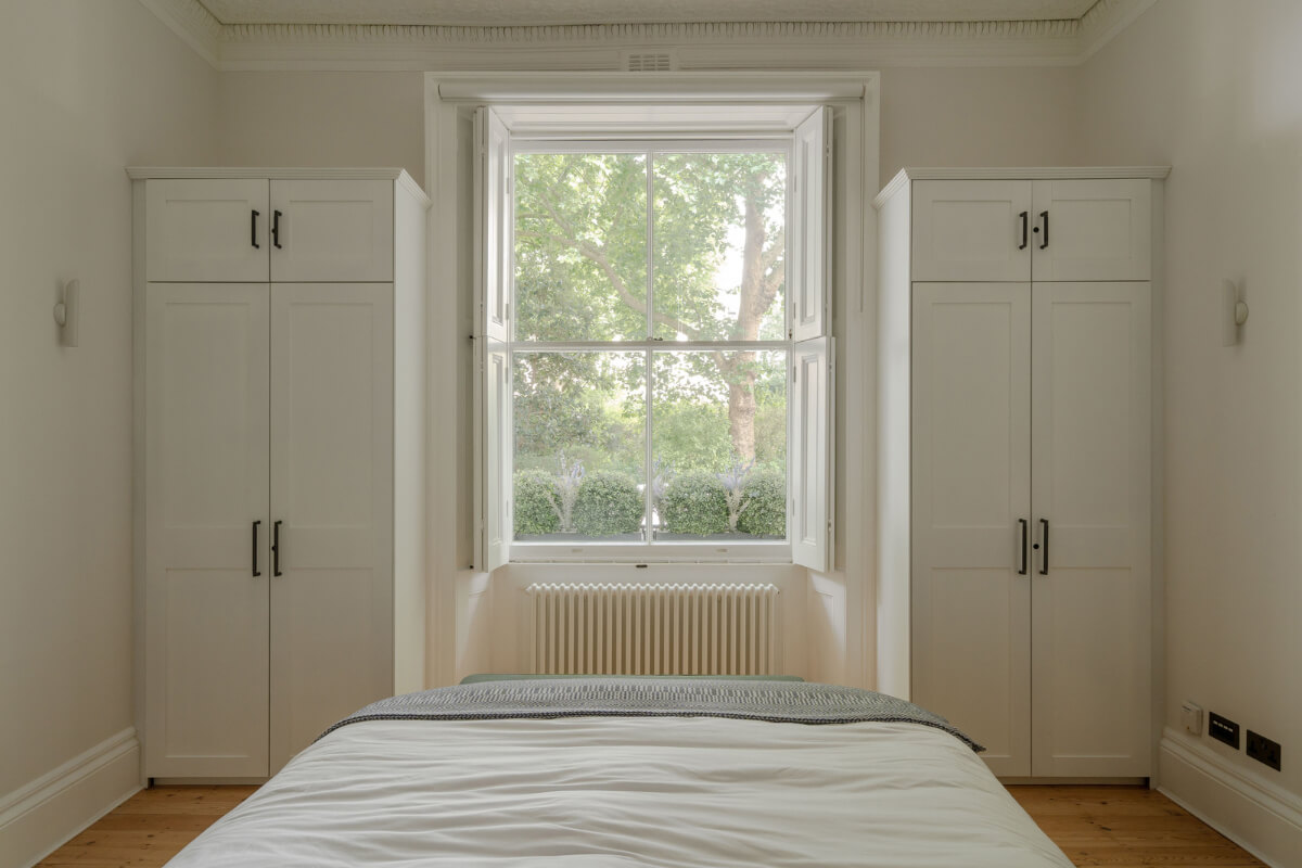 Historic Charm and Modern Design in a Light-Filled Pimlico Apartment 18 master bedroom window flanked by wardrobes