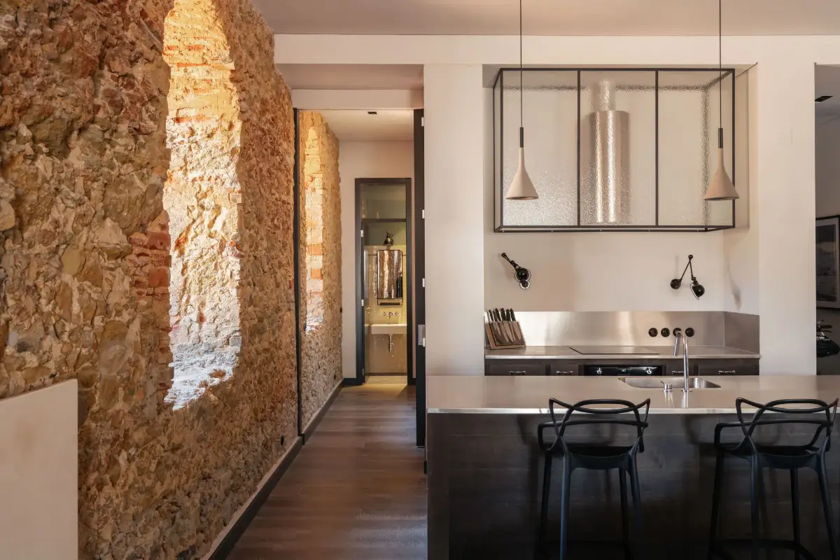 An Eye-Catching Stone Wall in a Beautiful Lisbon Apartment 4 modern kitchen stone wall