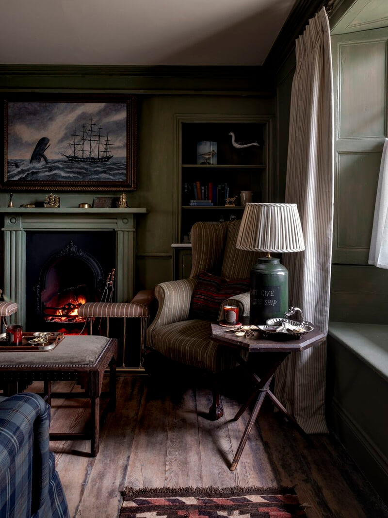 Bespoke Interiors and an Earthy Color Palette in a Historic Cottage 2 moody cottage sitting room wooden floorboards fireplace