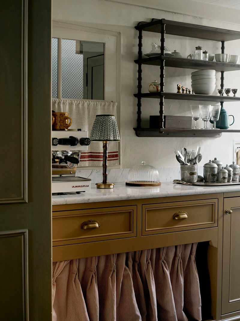 Bespoke Interiors and an Earthy Color Palette in a Historic Cottage 10 mustard kitchen cabinet skirting marble countertop