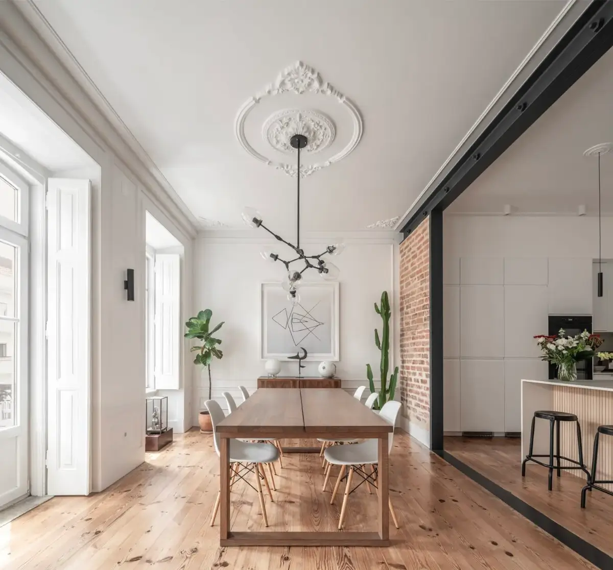 A Light-Filled Duplex Apartment in a Classical Lisbon Building 4 open plan kitchen and dining room exposed brick steel frame A Light-Filled Duplex Apartment in a Classical Lisbon Building