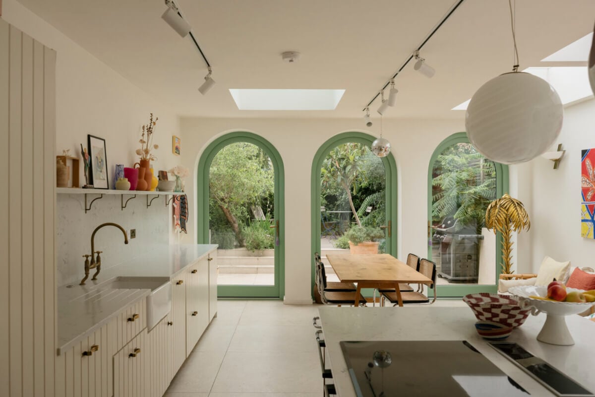 A Victorian Family House with a Tuscan-Inspired Kitchen Extension 10 open plan kitchen living space green arched windows