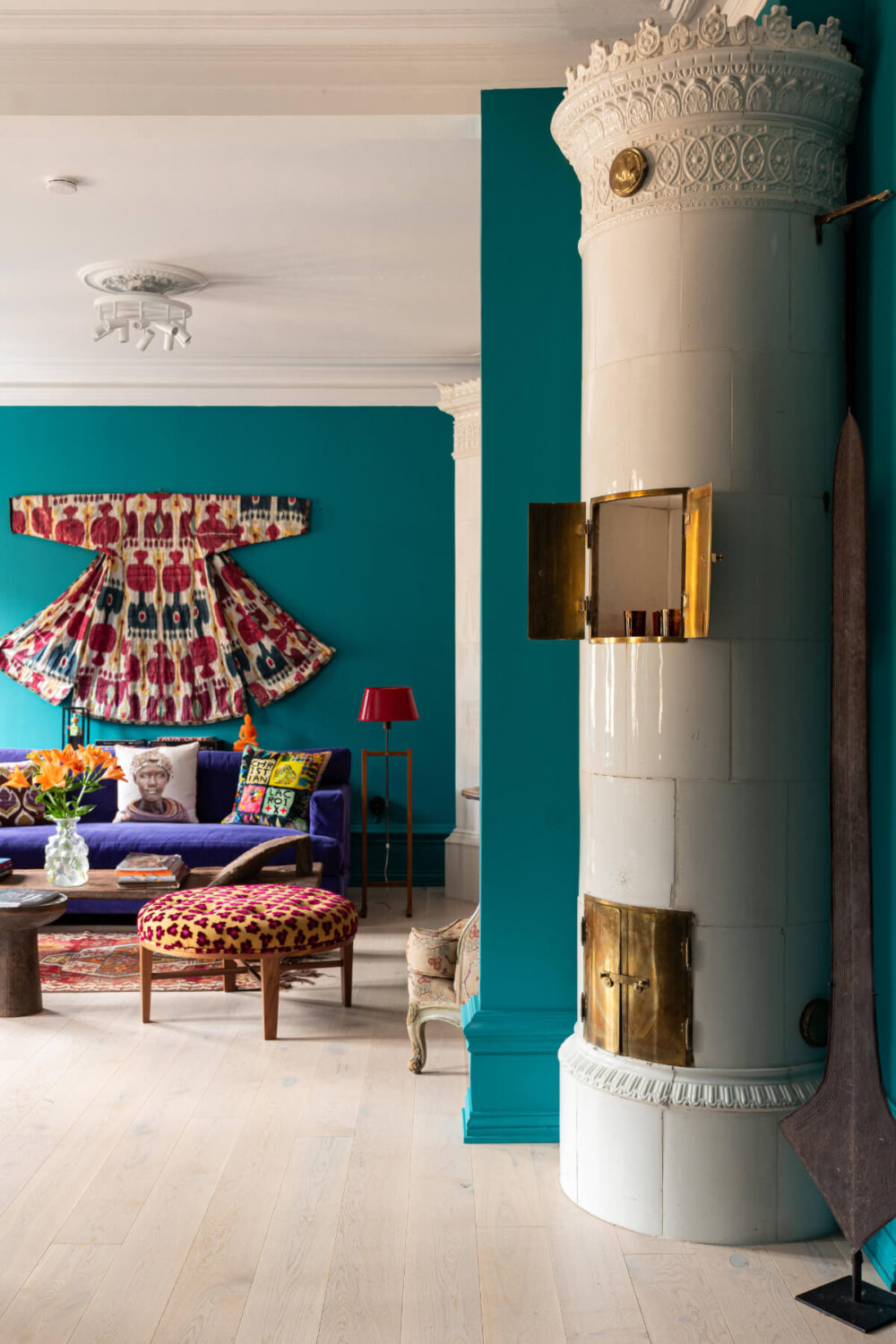 Bold Teal Walls and Antiques in a Turn-of-the-Century Apartment 6 open plan living room fireplace