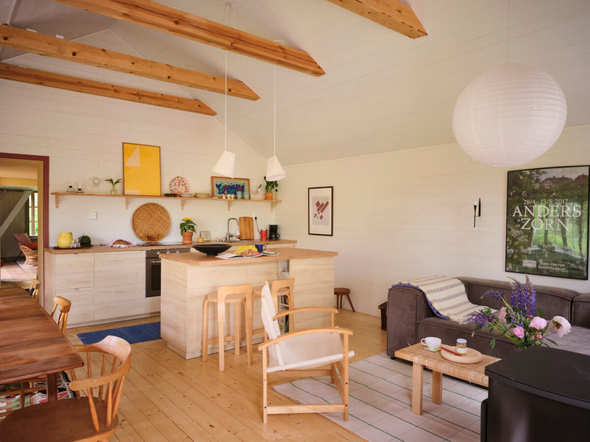 A Charming, Extended 19th-Century Log House in Sweden 2 open plan living space exposed beams