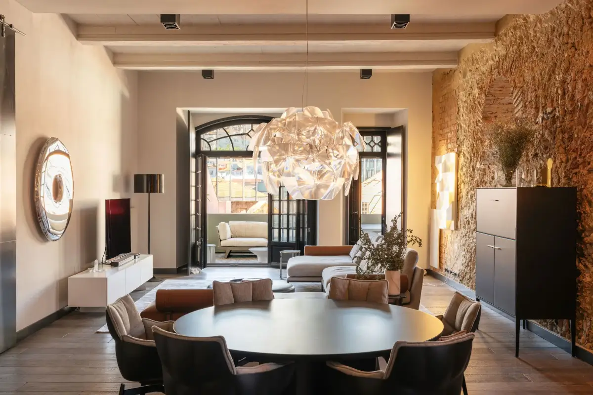An Eye-Catching Stone Wall in a Beautiful Lisbon Apartment 3 open plan living space wooden ceiling
