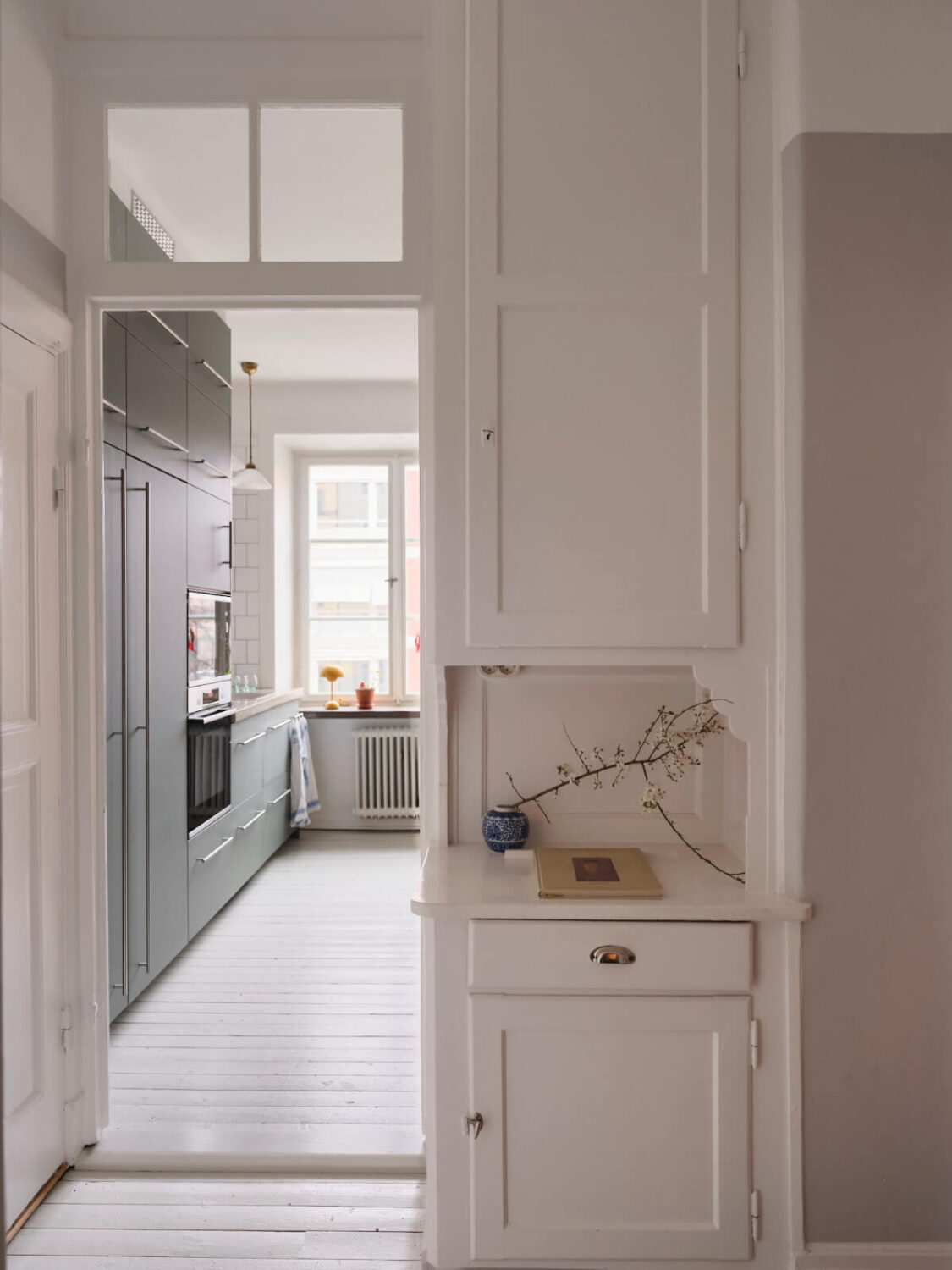 An Early 20th Century Apartment with a Muted Green Kitchen 12 original built-in cabinet