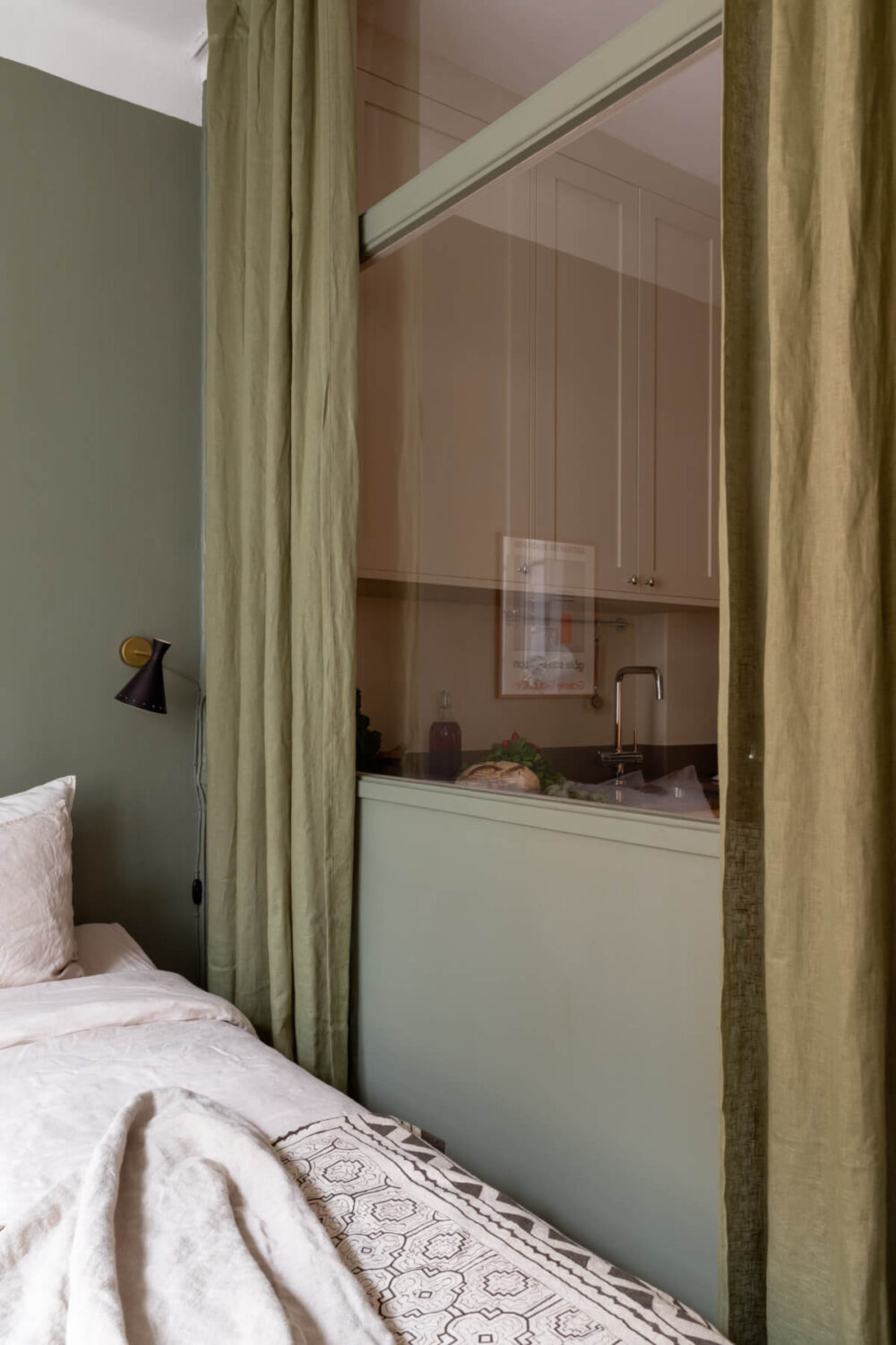 A Nice Color Palette and Original Elements in a Cozy 1930s Apartment 10 parition wall with glass toward kitchen green curtains