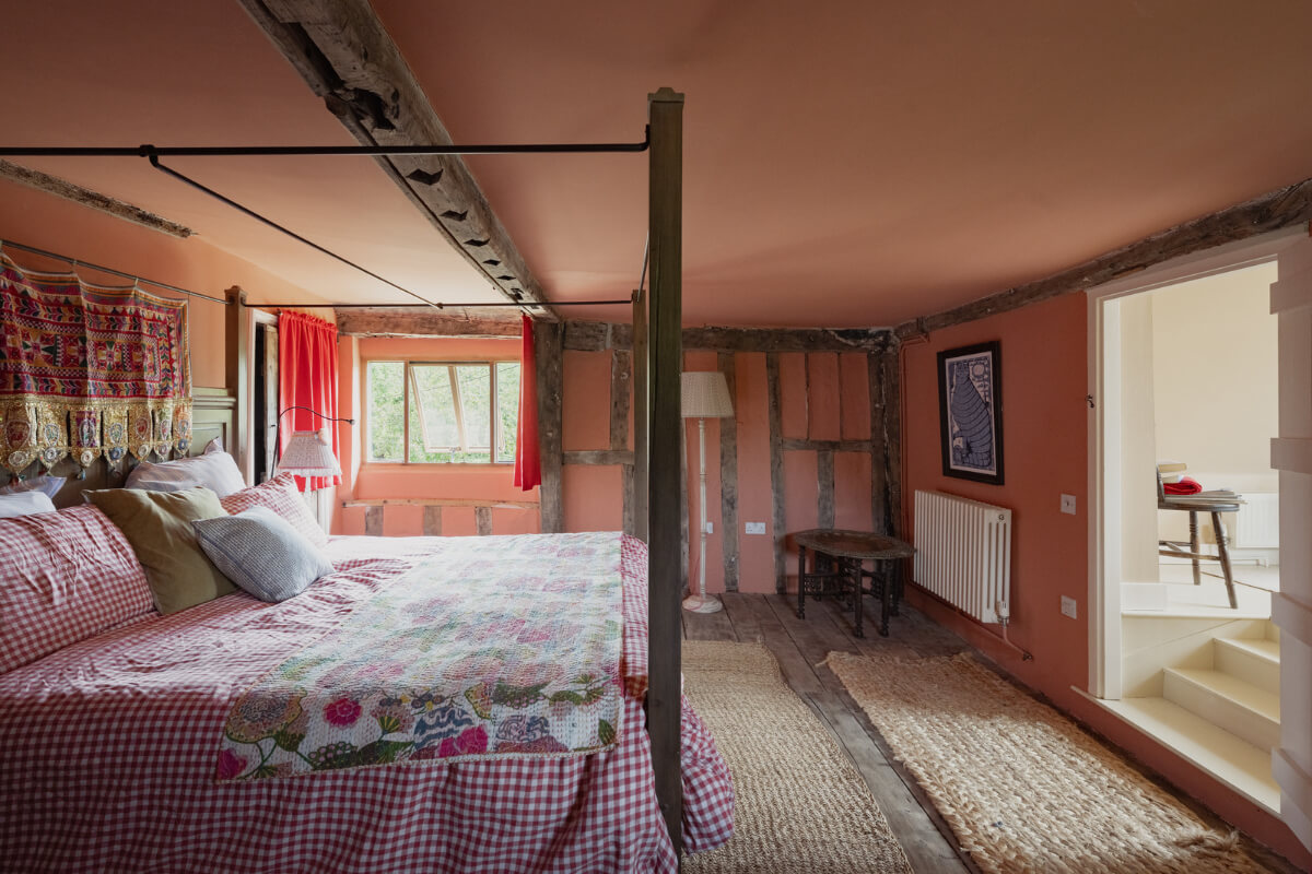 Colorful Interiors and Period Features in a 16th-Century Farmhouse 20 pink bedroom canopy bed colorful textiles