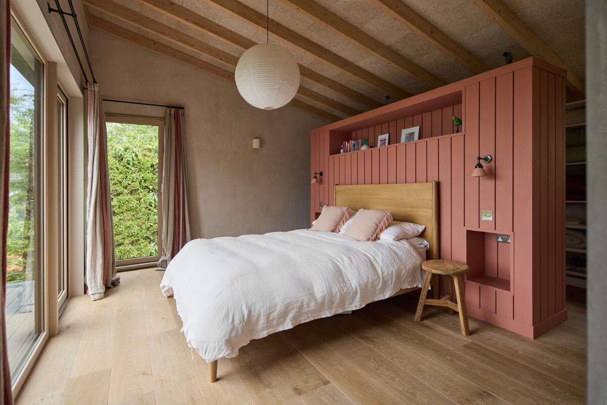 A Modern Bungalow with a Terrazzo Kitchen and Magnificent Views 11 pink headboard structure bedroom large windows