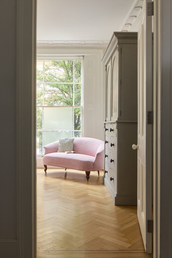 Light-Filled Interiors in a Grand Early Victorian House in Notting Hill 26 pink sofa herringbone parquet floor