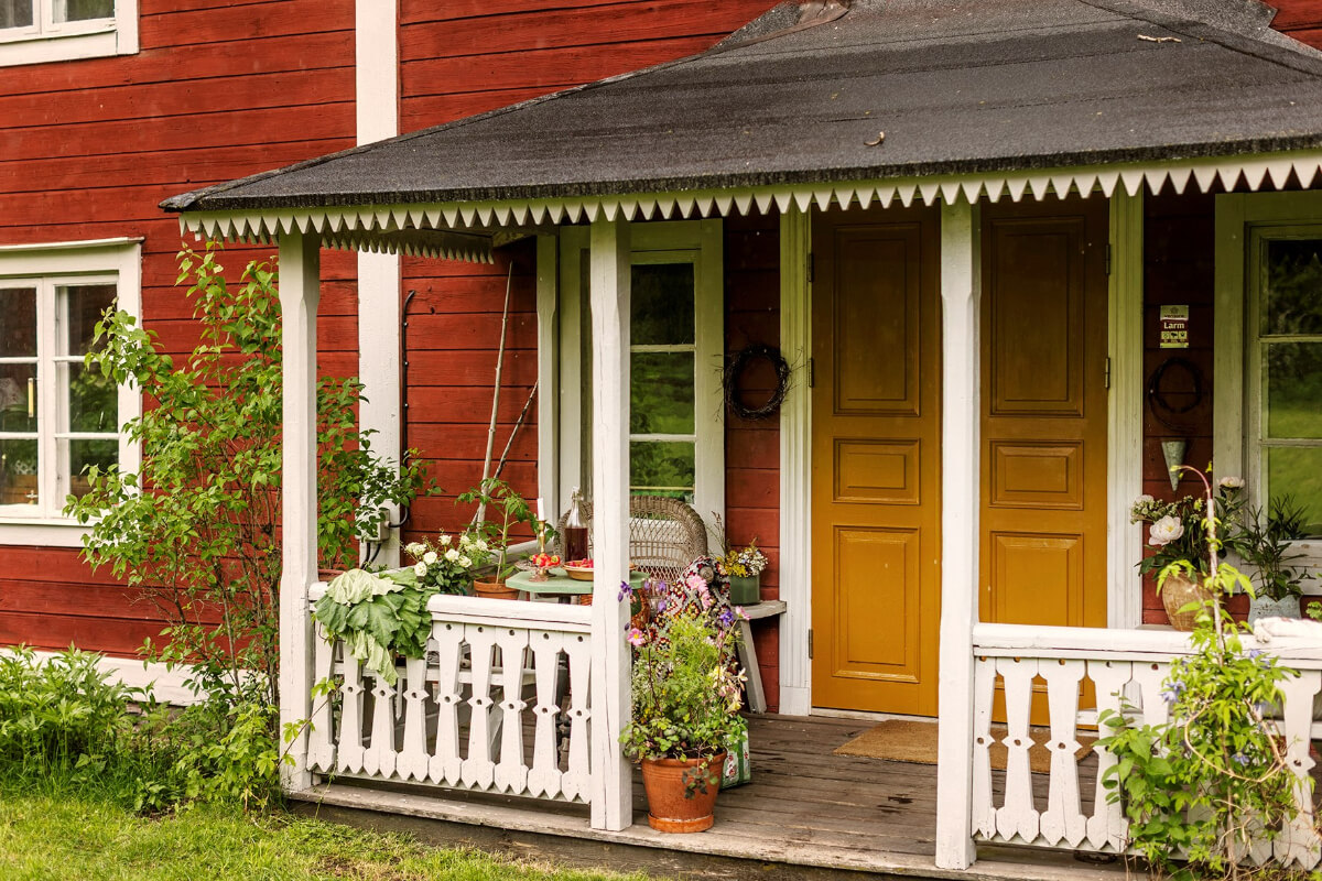 A Beautifully Preserved Historic Country House in Sweden 29 porch seating ochre yellow front door