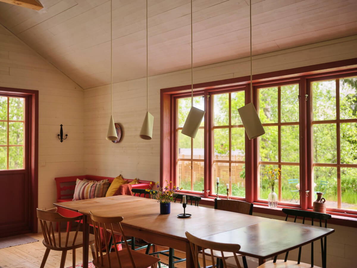 A Charming, Extended 19th-Century Log House in Sweden 10 red window frames dining table