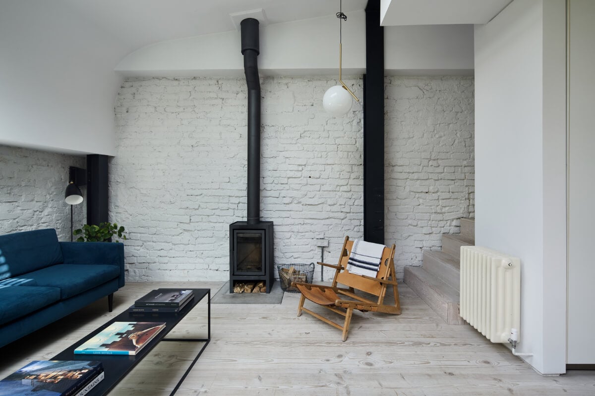 A Black and White Primrose Hill Mews House with a Roof Terrace 7 sitting room white painted brick wall