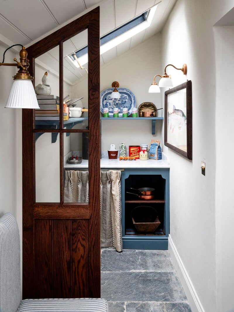 Bespoke Interiors and an Earthy Color Palette in a Historic Cottage 12 small utility room flagstone floor blue cabinets