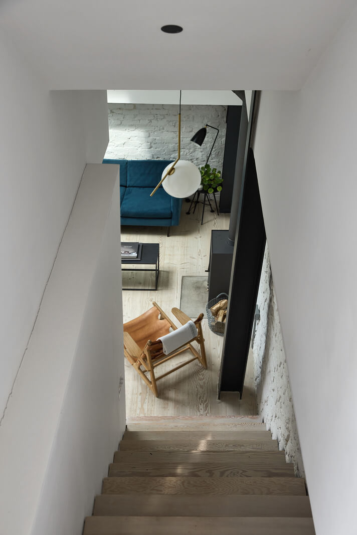 A Black and White Primrose Hill Mews House with a Roof Terrace 8 staircase view into living room