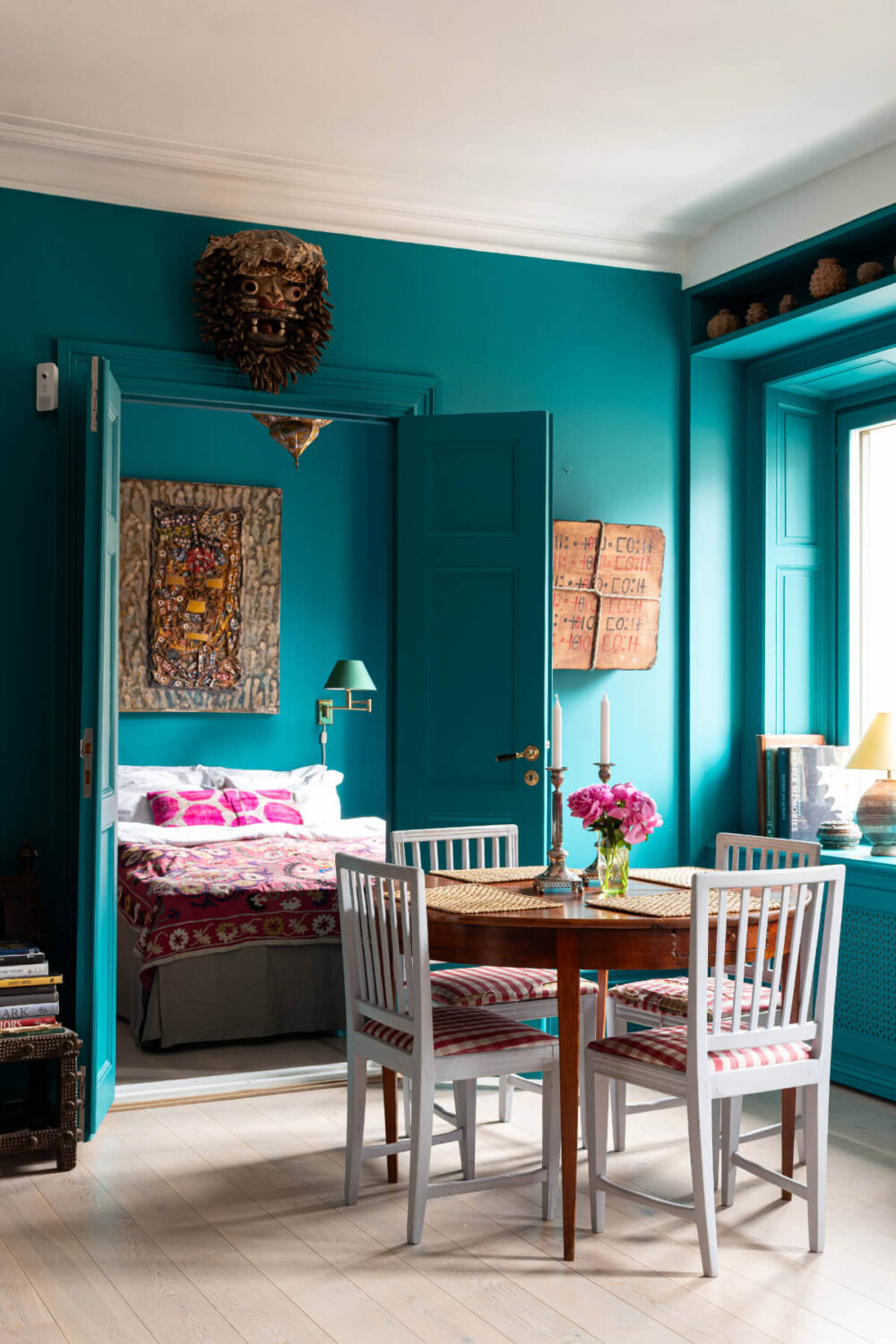 Bold Teal Walls and Antiques in a Turn-of-the-Century Apartment 8 teal apartment dining table double bedroom doors