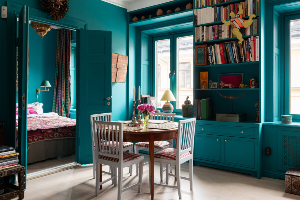 Bold Teal Walls and Antiques in a Turn-of-the-Century Apartment 7 teal living room double doors to bedroom