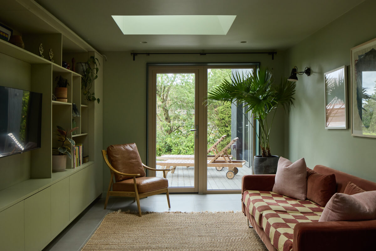 A Modern Bungalow with a Terrazzo Kitchen and Magnificent Views 10 television room green walls ceiling