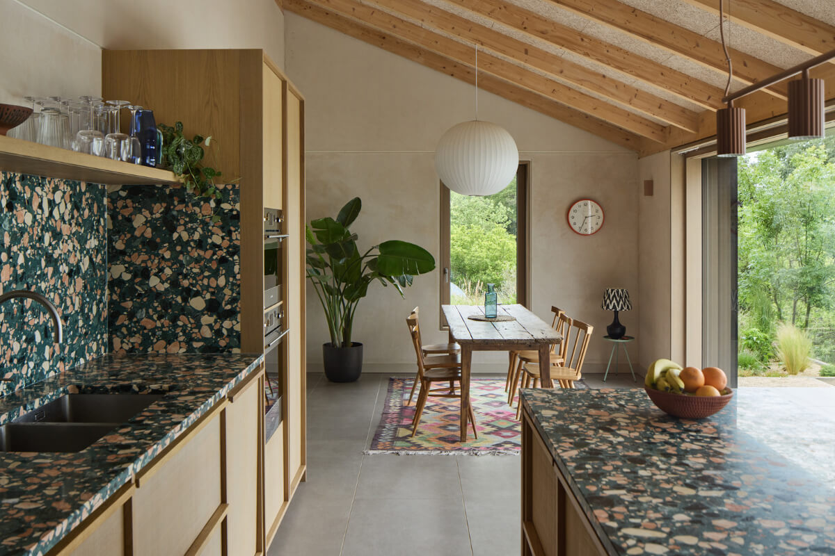 A Modern Bungalow with a Terrazzo Kitchen and Magnificent Views 6 terrazzo countertops kitchen with rustic wooden dining table
