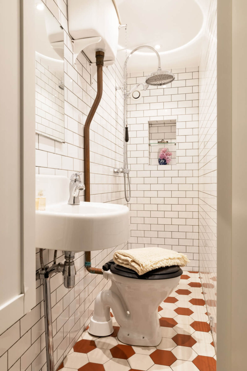 A Classic Late 19th-Century Apartment with a Private Courtyard Terrace 21 tiny bathroom white subwat tiles terracotta-colored hexagon floor tiles