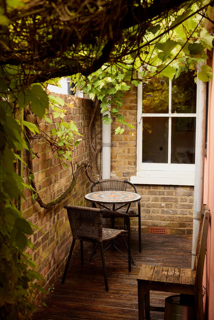 Cozy Living Spaces and Limewash Walls in an Artist's English Home 10 tiny patio garden