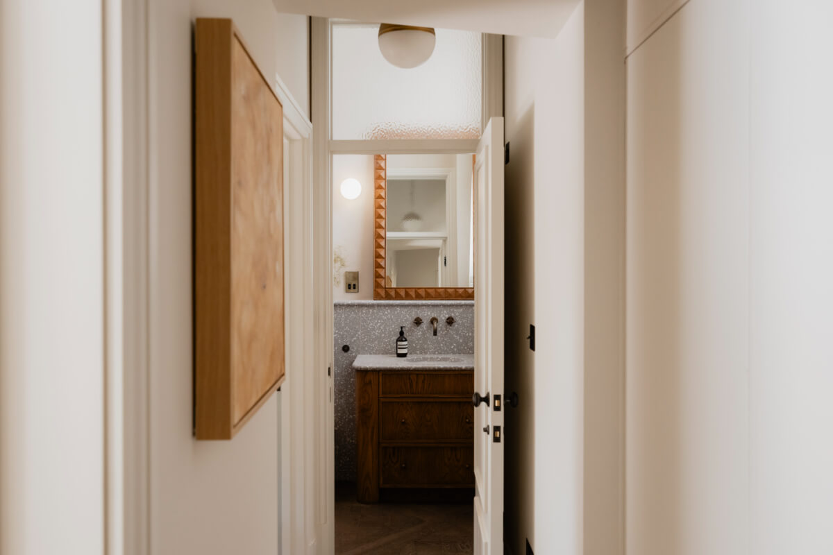 High Ceilings and Bespoke Design in a Stylish London Apartment 36 view into bathroom gray terrazzo tiles