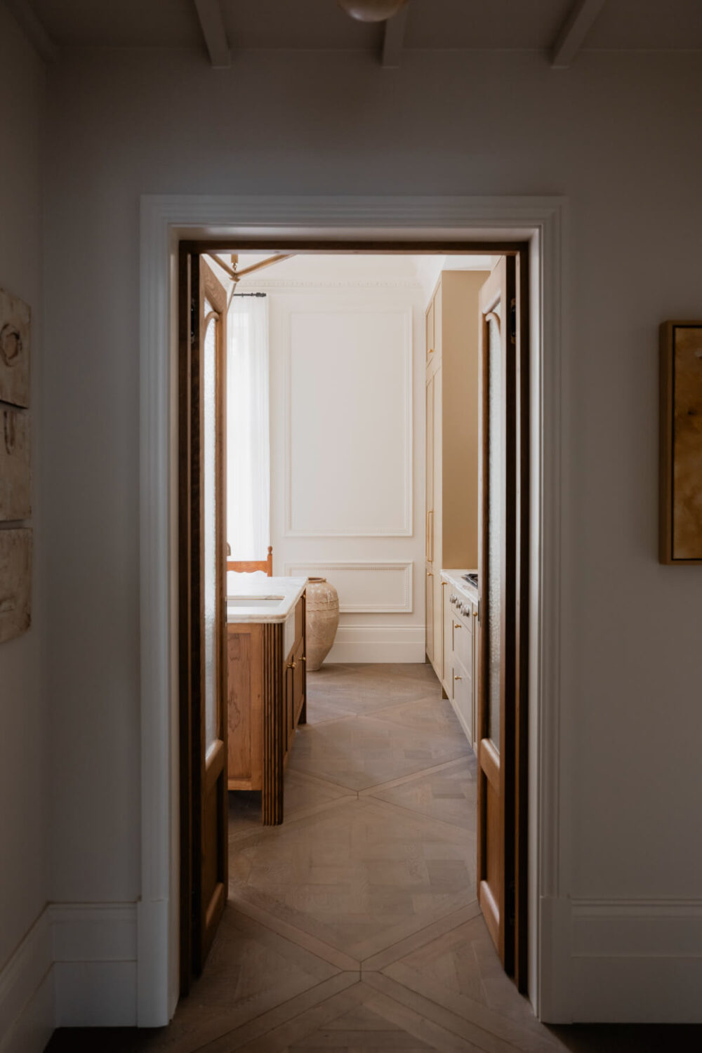 High Ceilings and Bespoke Design in a Stylish London Apartment 20 view into kitchen double oak doors