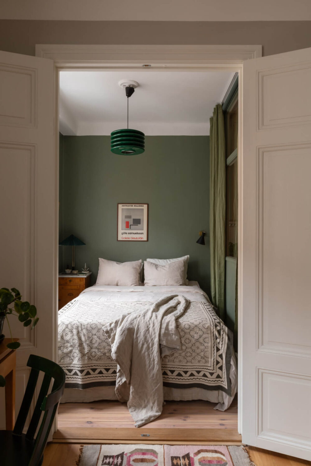 A Nice Color Palette and Original Elements in a Cozy 1930s Apartment 7 view into small green bedroom