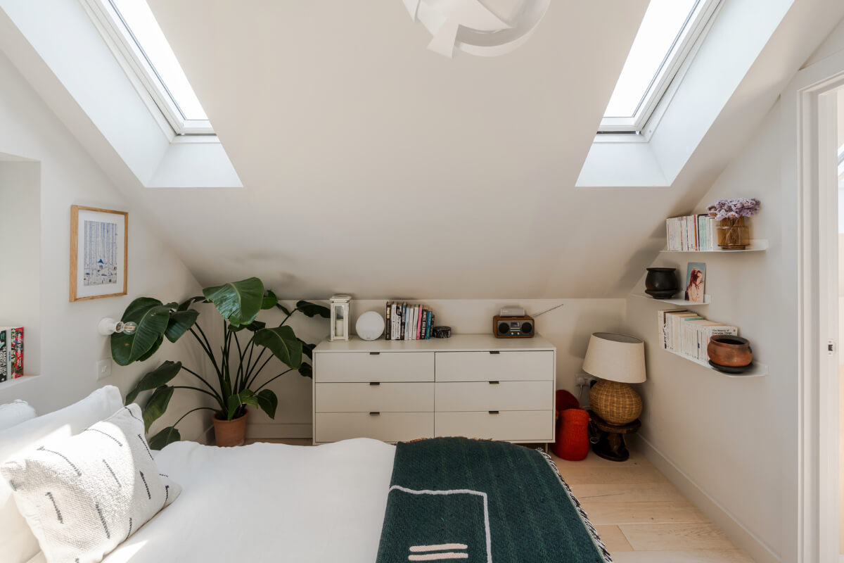 A High-Pitched Ceiling In a Light London Duplex Apartment 14 white bedroom slanted ceilings skylights low drawers