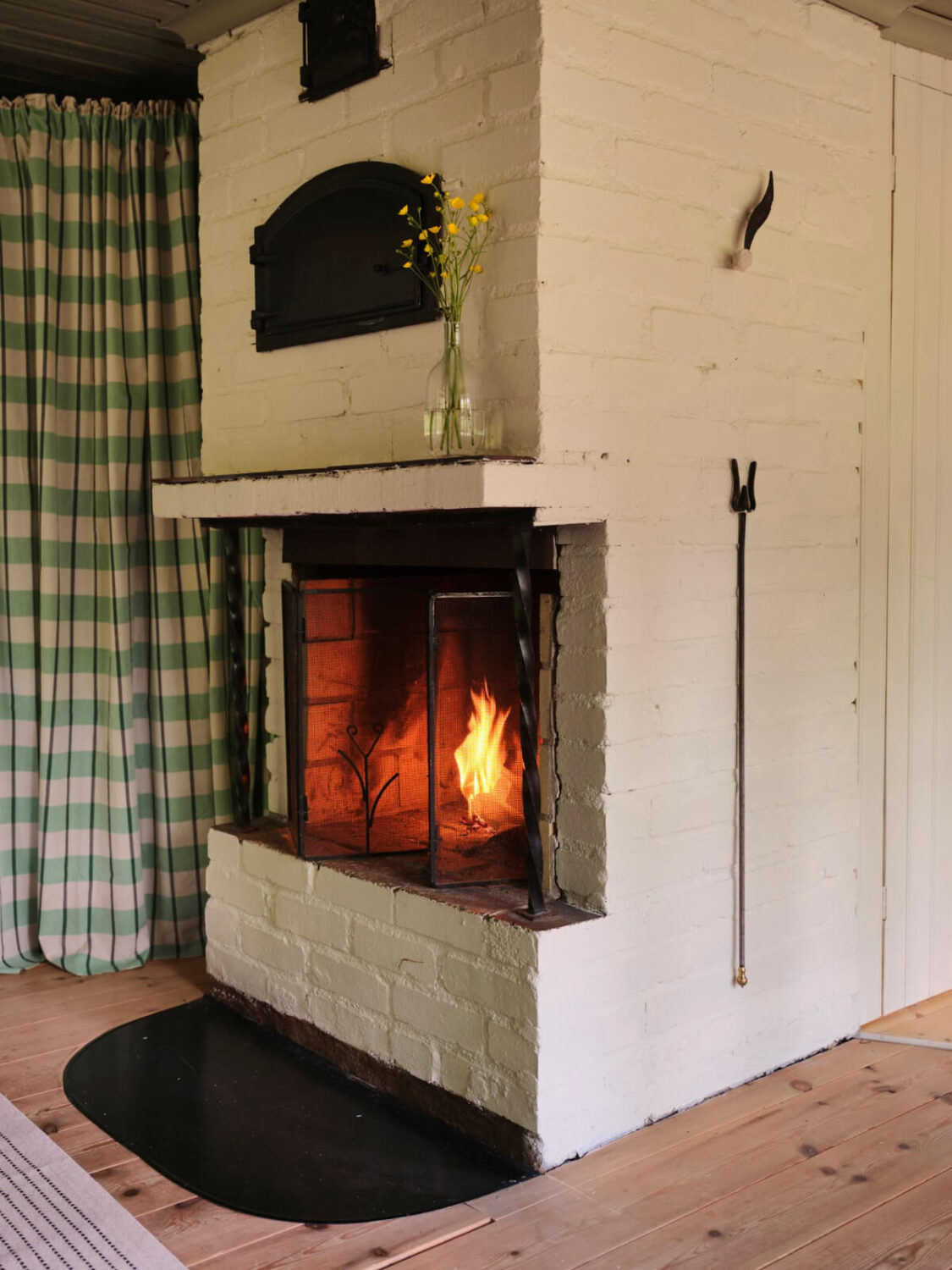 A Charming, Extended 19th-Century Log House in Sweden 21 white painted brick fireplace