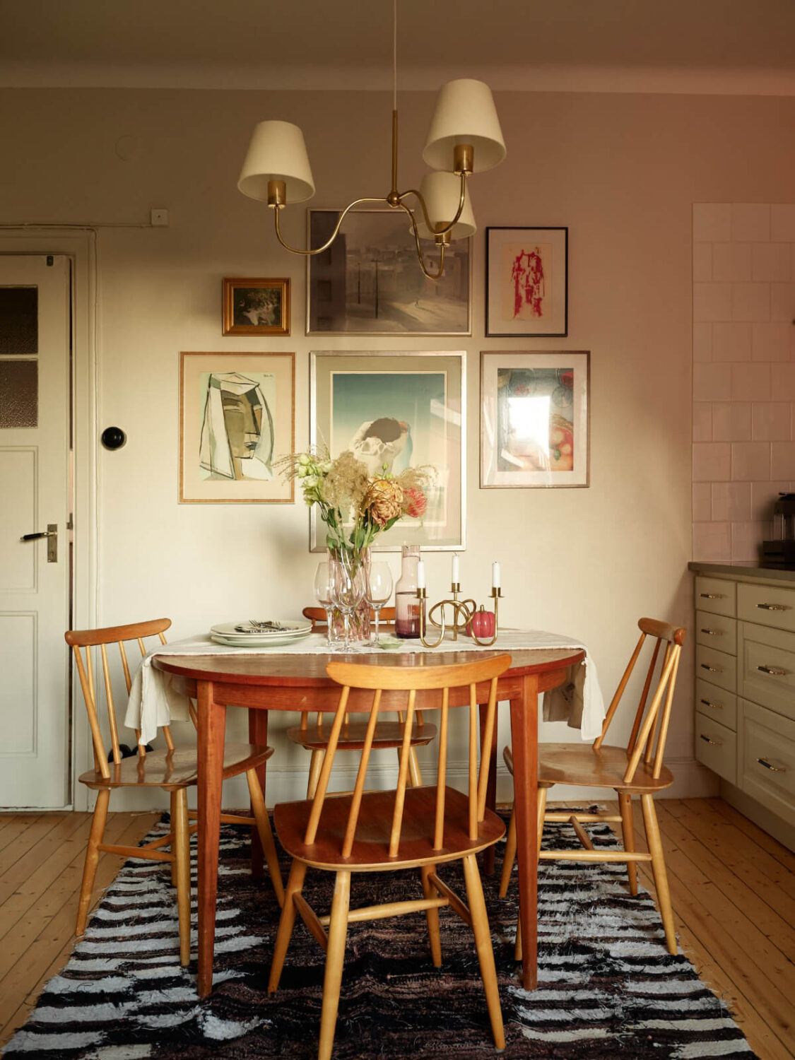 Historic Charm and an Industrial Glass Wall in a Stockholm Apartment 8 wooden dining table gallery wall