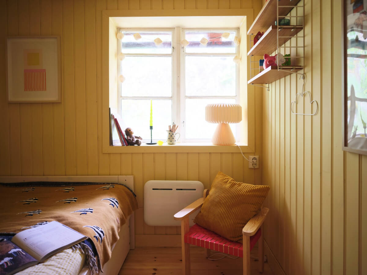 A Charming, Extended 19th-Century Log House in Sweden 28 yellow paneling bedroom