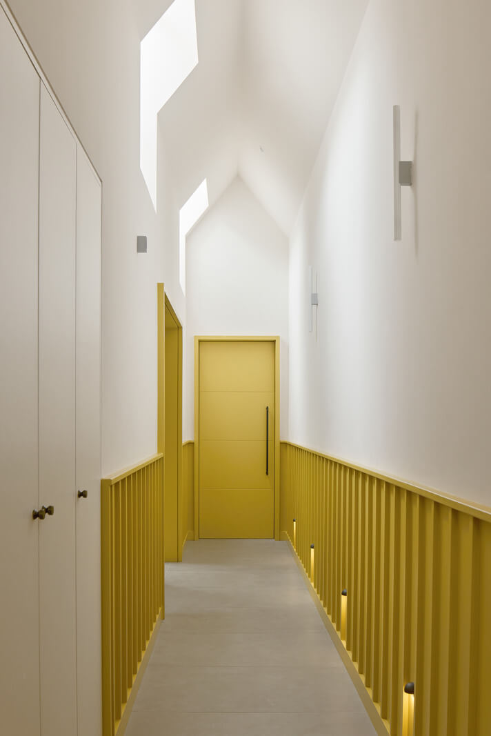 A Modern Bungalow with a Terrazzo Kitchen and Magnificent Views 17 yellow paneling door hall