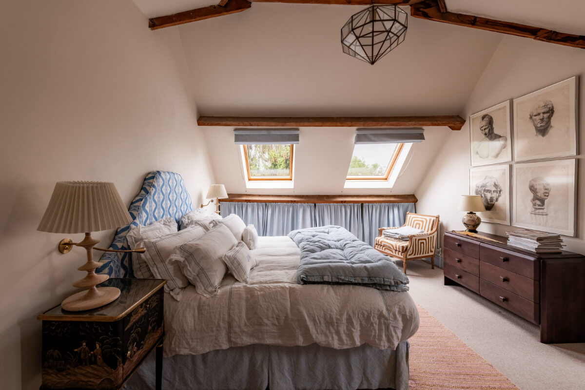 A Colorful Eclectic Victorian Maisonette Home in England 21 attic-bedroom-pitched-ceiling-wooden-beams