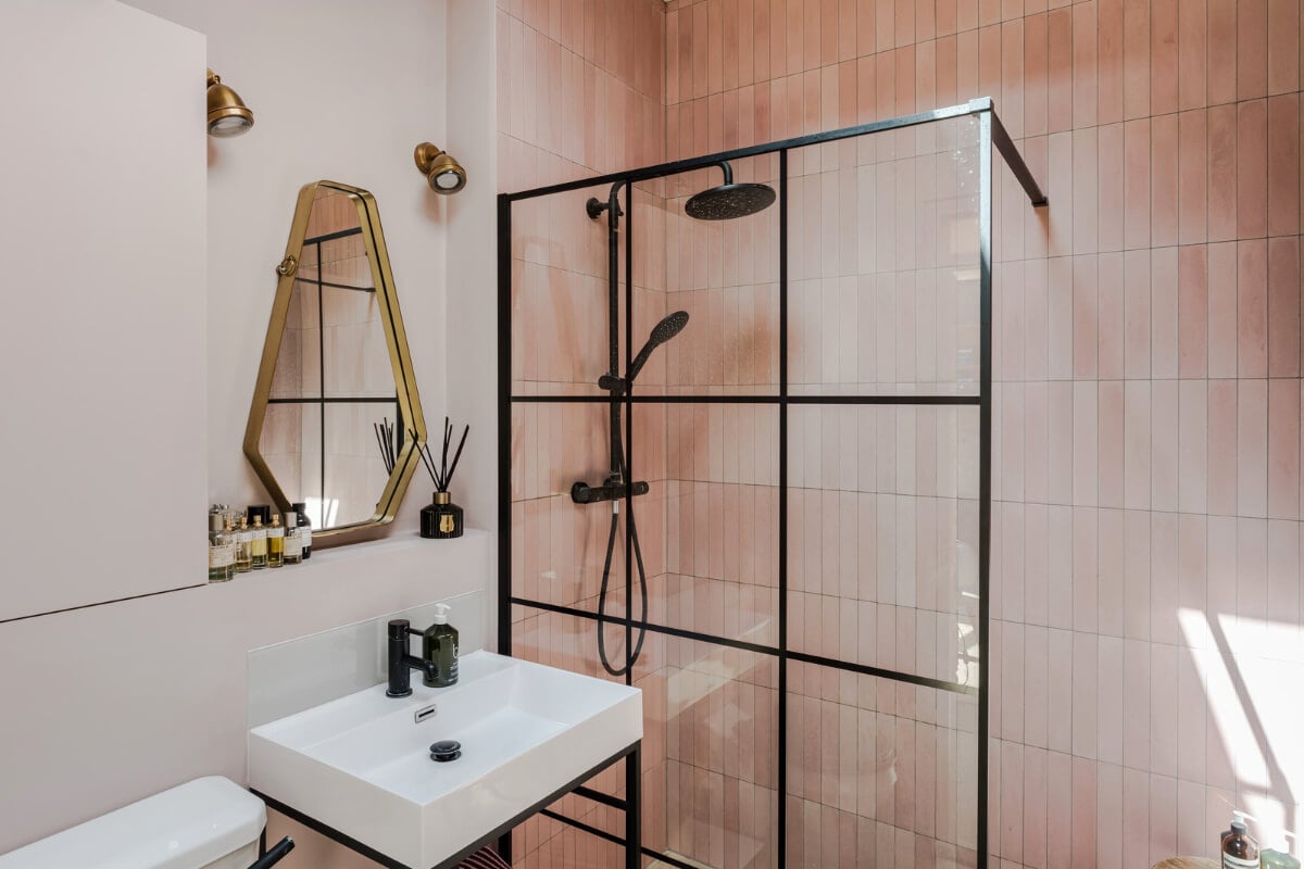 An Industrial Mews House with a Sebastian Cox deVOL Kitchen 23 bathroom pink tiles industrial glass shower wall