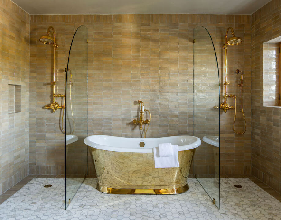 The Top Home Design Trends for 2026: Bold Color, Cozy Corners & Climate-Ready Living 21 bathroom with gold tub