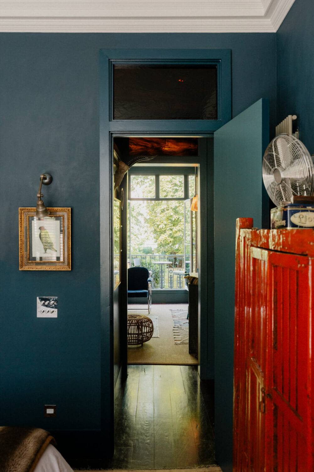 A Rich Color and Material Palette in a Small Victorian Apartment 15 bedroom view into hall and living room