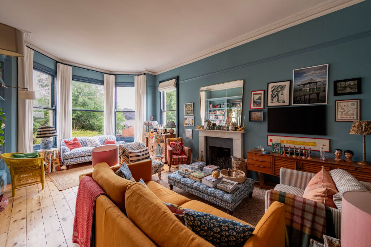 A Colorful Eclectic Victorian Maisonette Home in England 3 blue sitting room bay window ochre sofa