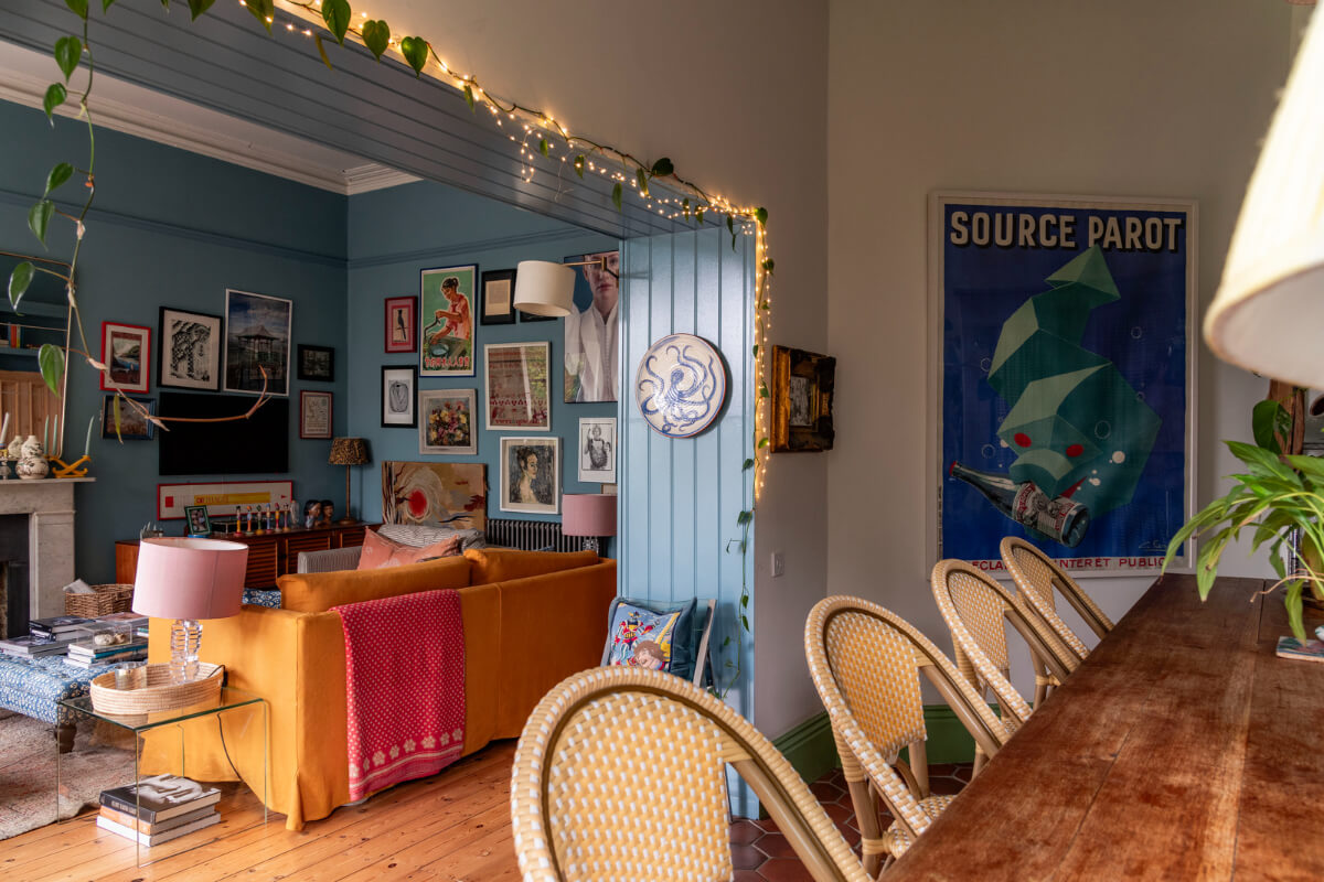 A Colorful Eclectic Victorian Maisonette Home in England 4 blue sitting room ochre sofa string lights