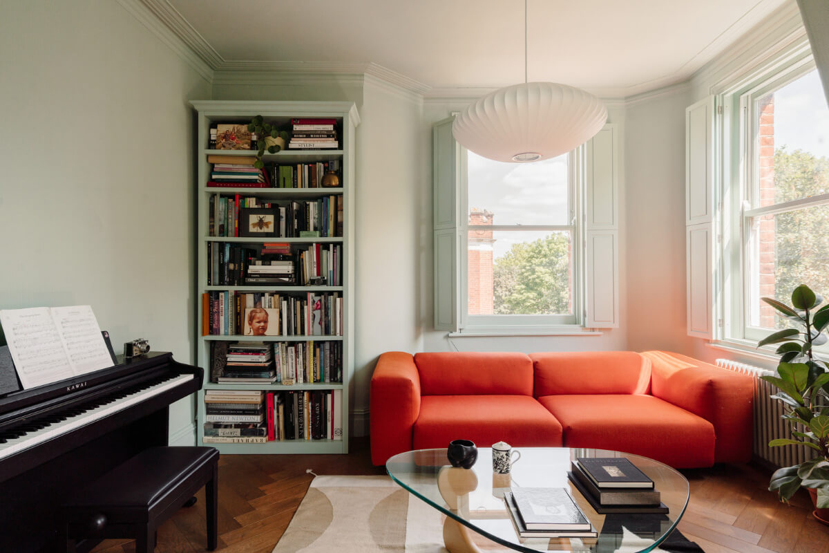 Pastel Tones and Deep Yellow in an Early 20th-Century London Apartment 1 corner living room orange sofa