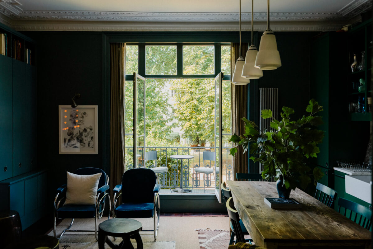 A Rich Color and Material Palette in a Small Victorian Apartment 2 dark blue open-plan living room with balcony