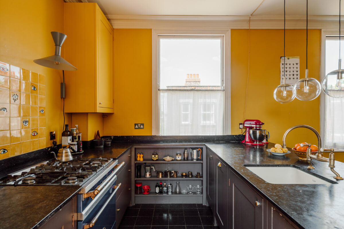 Pastel Tones and Deep Yellow in an Early 20th-Century London Apartment 10 dark gray kitchen cabinets yellow walls