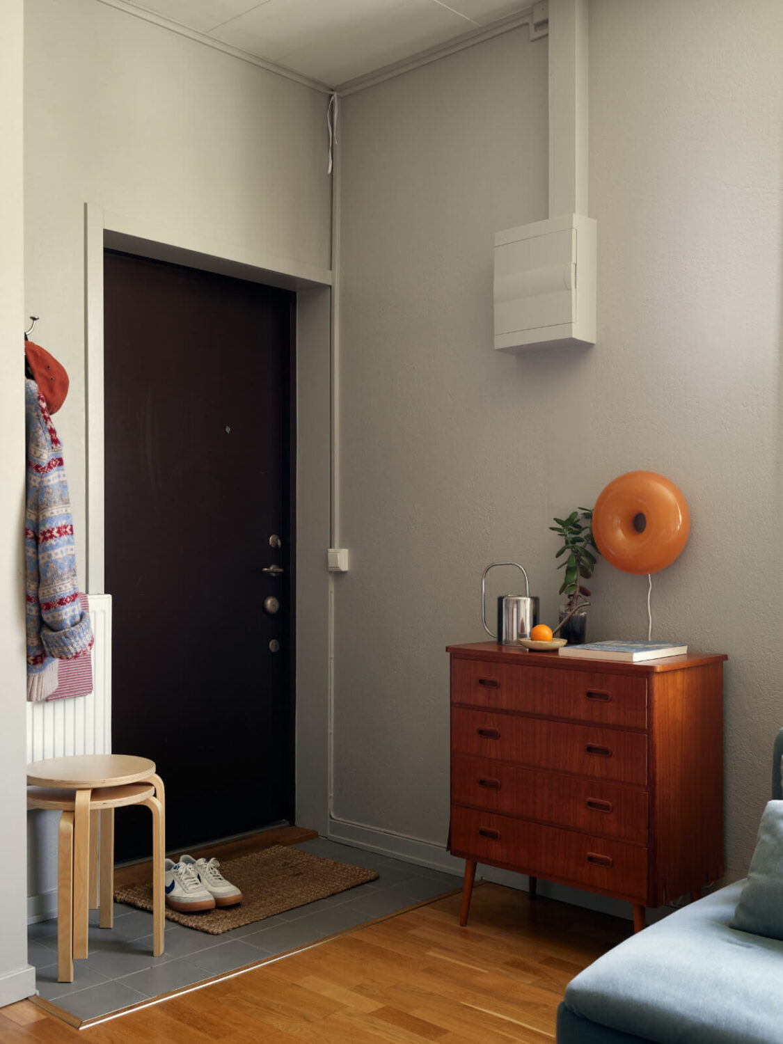 A Tiny Apartment with a Semi-Open Floorplan and a Pink Kitchen 17 entry hall ikea wall lamp
