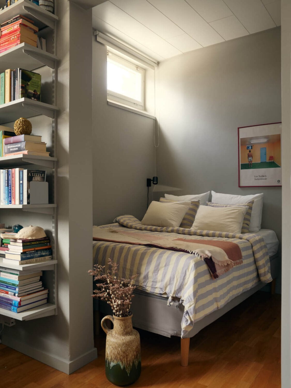 A Tiny Apartment with a Semi-Open Floorplan and a Pink Kitchen 14 gray bedroom niche high window